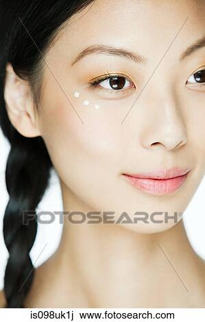 Young woman with eye cream View Large Photo Image Stock Image - Young woman with eye cream. Fotosearch