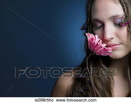 Stock Image - Young woman with flower. Fotosearch
