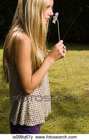 Stock Photo - Young woman with flower. Fotosearch