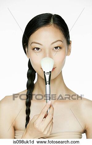 Young woman with makeup brush View Large Photo Image Stock Image - Young woman with makeup brush. Fotosearch