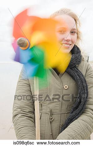 Young woman with pinwheel View Large Photo Image Stock Image - Young woman with pinwheel. Fotosearch