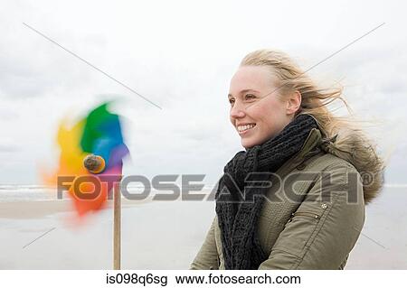 Stock Image - Young woman with pinwheel. Fotosearch
