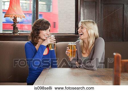 Young women in bar View Large Photo Image Stock Image - Young women in bar. Fotosearch