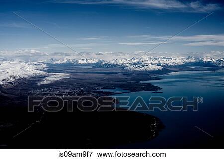 "Aerial view of city, coastline and distant snow covered mountains, Ushuaia, Tierra del Fuego, Argentina" View Large Photo Image Stock Photo - "Aerial view of city, coastline and distant snow covered mountains, Ushuaia, Tierra del Fuego, Argentina". Fotosearch