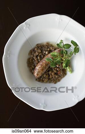 Bowl of brown lentils and sausage with herb garnish View Large Photo Image Picture - Bowl of brown lentils and sausage with herb garnish. Fotosearch