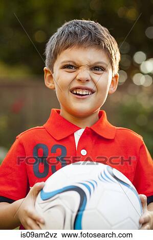 "Boy with football, making faces" View Large Photo Image Stock Photo - "Boy with football, making faces". Fotosearch