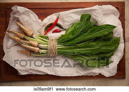 Stock Image - Bunch of fresh vegetables wrapped in string. Fotosearch