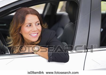 Business woman leaning out of car window View Large Photo Image Stock Image - Business woman leaning out of car window. Fotosearch