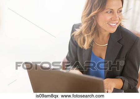 Business woman using laptop View Large Photo Image Stock Photo - Business woman using laptop. Fotosearch