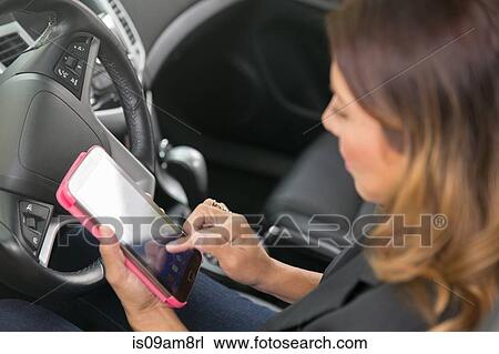Business woman using smartphone in car View Large Photo Image Stock Image - Business woman using smartphone in car. Fotosearch