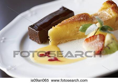 Dessert plate with chocolate slice and tart with sliced fruits View Large Photo Image Stock Photography - Dessert plate with chocolate slice and tart with sliced fruits. Fotosearch