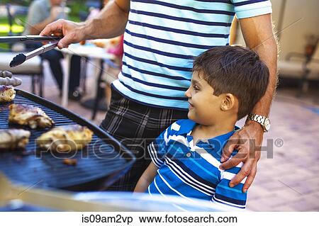 Father and son at barbecue grill in garden View Large Photo Image Stock Photography - Father and son at barbecue grill in garden. Fotosearch