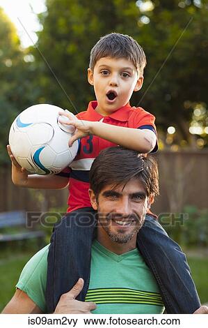 Father and son playing piggyback ride in garden View Large Photo Image Stock Photo - Father and son playing piggyback ride in garden. Fotosearch
