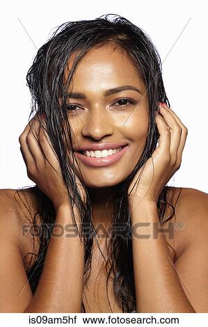 Stock Image - Female model covering ears with hands. Fotosearch