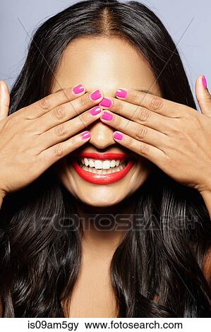 Stock Photo - Female model covering eyes with hands. Fotosearch