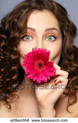 Female model covering mouth with flower View Large Photo Image Stock Photograph - Female model covering mouth with flower. Fotosearch