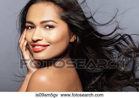 "Female model smiling, looking over shoulder" View Large Photo Image Stock Photo - "Female model smiling, looking over shoulder". Fotosearch