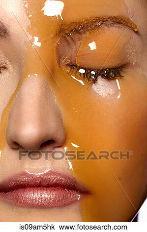 Female model's face covered in honey View Large Photo Image Stock Image - Female model's face covered in honey. Fotosearch