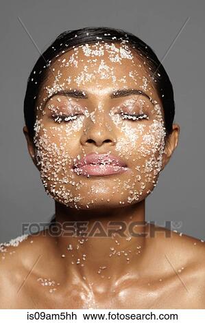 Stock Image - Female model's face covered in sugar. Fotosearch