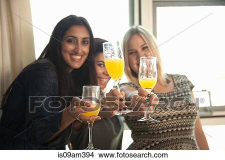 "Group of female friends holding glasses, making toast" View Large Photo Image Picture - "Group of female friends holding glasses, making toast". Fotosearch