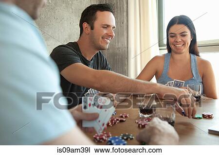 Group of friends playing cards around table View Large Photo Image Stock Image - Group of friends playing cards around table. Fotosearch
