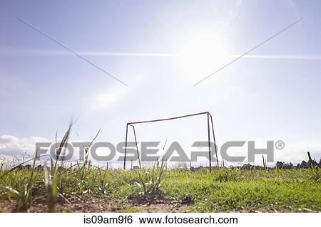 Stock Photograph - "Low angle view of soccer goalpost on rough field, Buenos Aires, Argentina". Fotosearch