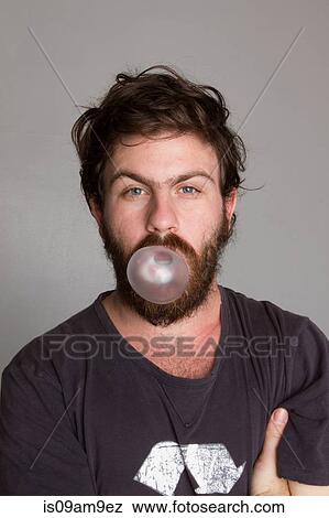 Man blowing a bubble gum bubble View Large Photo Image Stock Photo - Man blowing a bubble gum bubble. Fotosearch