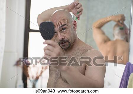 Mature man shaving his head in bathroom View Large Photo Image Stock Image - Mature man shaving his head in bathroom. Fotosearch