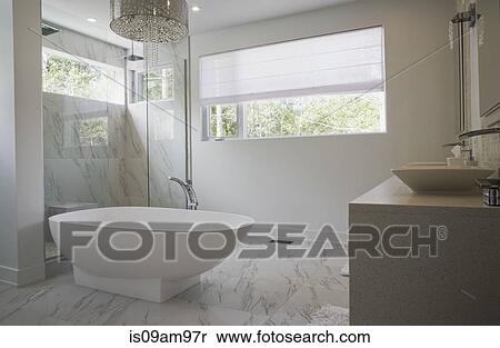 Modern interior design luxury bathroom with bath and glass walled shower View Large Photo Image Stock Photography - Modern interior design luxury bathroom with bath and glass walled shower. Fotosearch