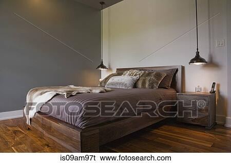 Stock Photograph - Modern interior design luxury bedroom with queen sized bed and wooden floor. Fotosearch