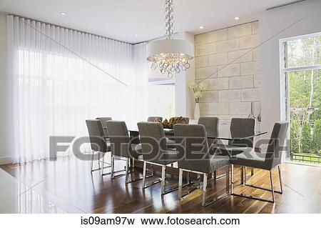 Modern interior design luxury dining room with glass dining table and grey upholstered dining chairs View Large Photo Image Stock Photo - Modern interior design luxury dining room with glass dining table and grey upholstered dining chairs. Fotosearch