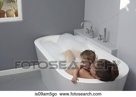 Mother and baby girl in bathtub View Large Photo Image Picture - Mother and baby girl in bathtub. Fotosearch