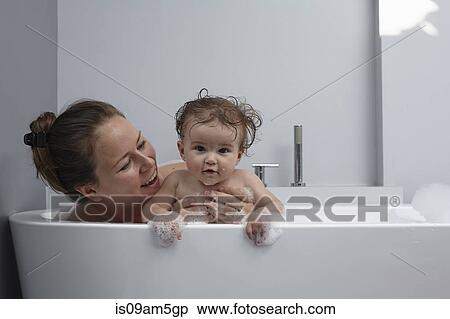 Mother and baby girl in bathtub View Large Photo Image Stock Photography - Mother and baby girl in bathtub. Fotosearch