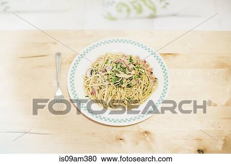 "Noodle meal on table with fork, overhead view" View Large Photo Image Stock Image - "Noodle meal on table with fork, overhead view". Fotosearch