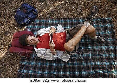 "Overhead view of young male camper lying on picnic blanket in forest, Los Angeles, California, USA" View Large Photo Image Stock Image - "Overhead view of young male camper lying on picnic blanket in forest, Los Angeles, California, USA". Fotosearch
