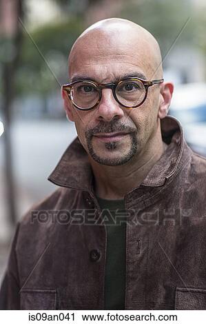 Stock Image - Portrait of confident mature man on street. Fotosearch