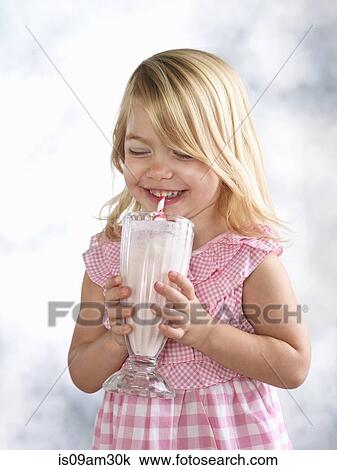 Portrait of giggling female toddler drinking glass of milk View Large Photo Image Stock Image - Portrait of giggling female toddler drinking glass of milk. Fotosearch