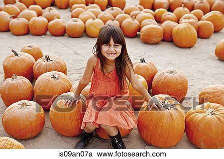 Portrait of girl sitting on pumpkin in farmyard View Large Photo Image Stock Image - Portrait of girl sitting on pumpkin in farmyard. Fotosearch