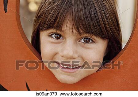 Portrait of girl with her head through farmyard fence View Large Photo Image Stock Photo - Portrait of girl with her head through farmyard fence. Fotosearch