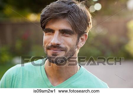 Stock Image - Portrait of man looking into distance. Fotosearch