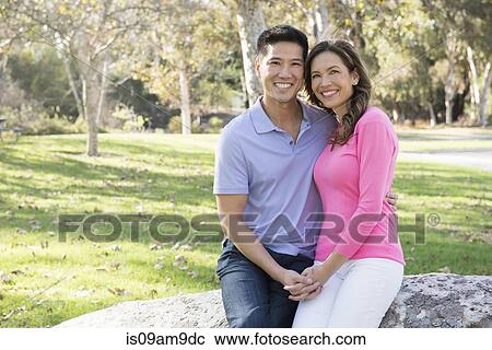 Portrait of mature couple holding hands in park View Large Photo Image Stock Image - Portrait of mature couple holding hands in park. Fotosearch