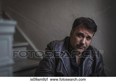 Portrait of mature man sitting alone on stairway View Large Photo Image Stock Image - Portrait of mature man sitting alone on stairway. Fotosearch