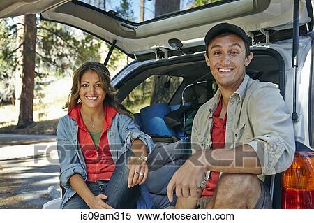 "Portrait of young camping couple sitting on car boot, Los Angeles, California, USA" View Large Photo Image Stock Photography - "Portrait of young camping couple sitting on car boot, Los Angeles, California, USA". Fotosearch