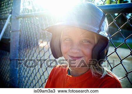 Stock Image - Portrait of young girl wearing baseball kit. Fotosearch