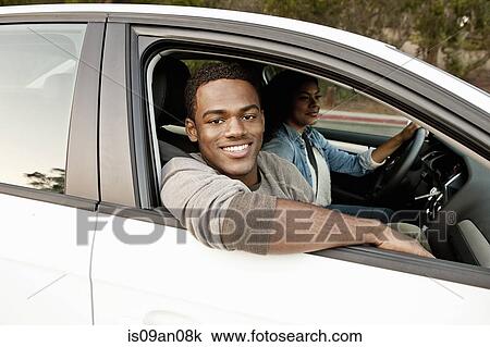Portrait of young man looking out of car window View Large Photo Image Stock Image - Portrait of young man looking out of car window. Fotosearch