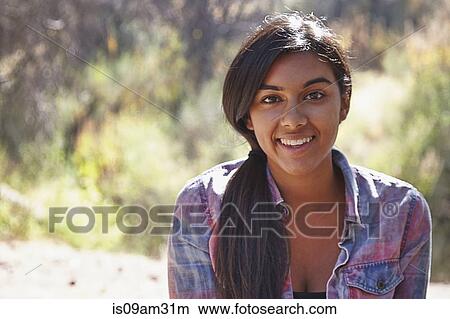 Picture - "Portrait of young woman in forest, Los Angeles, California, USA". Fotosearch