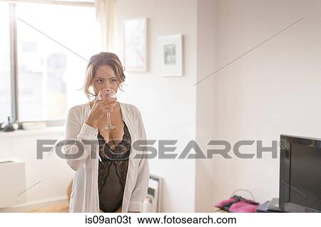 Sexy mid adult woman drinking white wine in living room View Large Photo Image Stock Photograph - Sexy mid adult woman drinking white wine in living room. Fotosearch