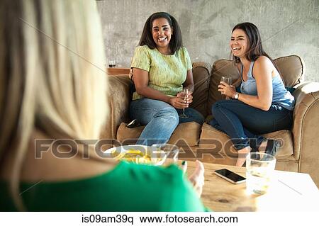 Small group of female friends chatting and drinking wine View Large Photo Image Stock Photography - Small group of female friends chatting and drinking wine. Fotosearch