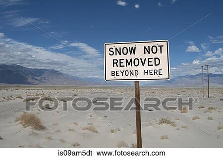 Stock Photograph - "Snow warning sign in desert, Death Valley, California, USA". Fotosearch