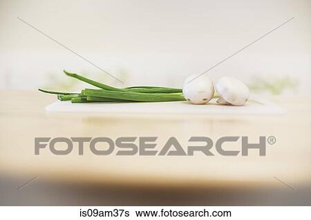 Spring onions and mushrooms against white background View Large Photo Image Stock Photograph - Spring onions and mushrooms against white background. Fotosearch